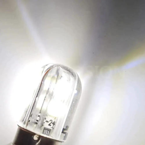 Close-up of BA9S LED Indicator Bulb 120V AC DC in cool white light, ideal for industrial control panels, switchgear status, and machine tool signals.