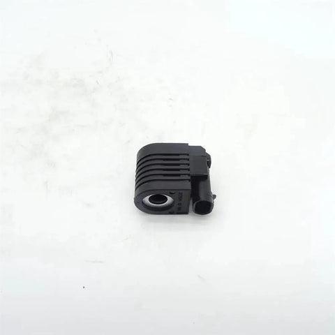 KV23085 solenoid valve coil for CT322 loader skid-steer; black ribbed plastic housing with side connector