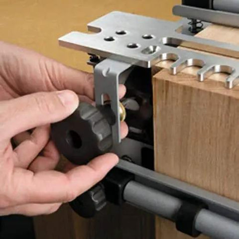 Hands adjusting Dovetail Jig Kit For Woodworking With Mini Templates 4211 4213 And 4215 For Half Blind Dovetails on a wooden block