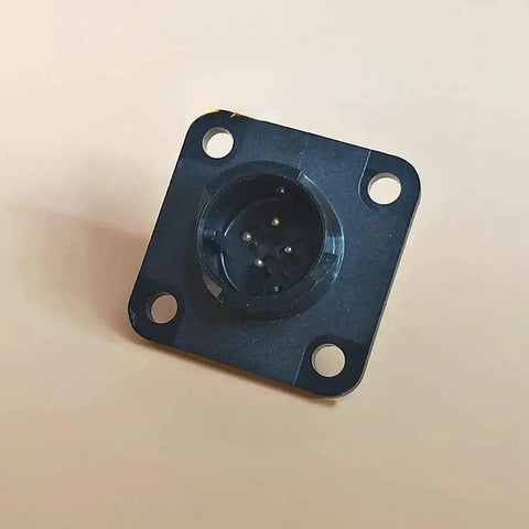 Servo motor encoder plug on a black square mounting plate with four corner holes; circular multi-pin connector.