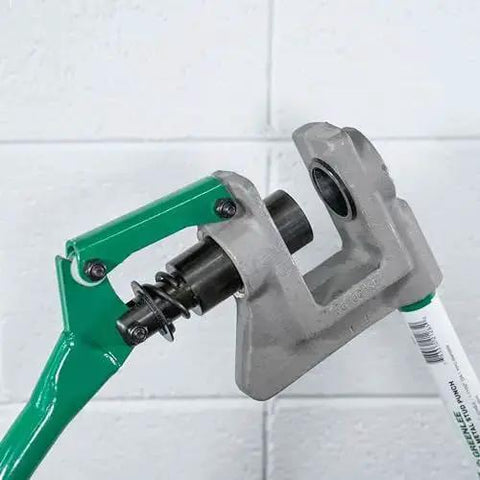 One Stroke Manual Metal Stud Punch Tool 1-11/32 Inch with aluminum head and contoured handle in action on steel stud.