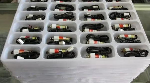 Tray of G130535 Push Pull Solenoid Electromagnet Linear Motor Valve 24V 2W High Torque 50g devices, organized in compartments.