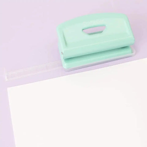 Mint 2 Hole Puncher With Waste Tray, 10 Sheet Capacity, Metal Puncher With Adjustable Guide and Non Slip Base on purple background