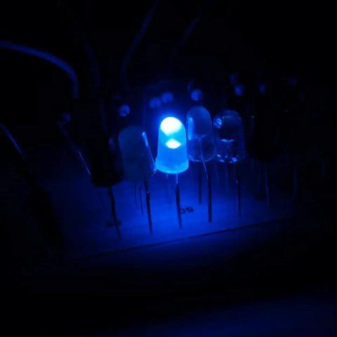 Blue 5mm LEDs close-up with through-hole leads; several lit diodes in a row