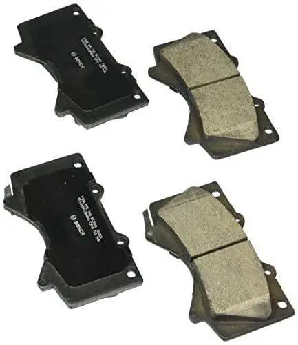 BOSCH front ceramic brake pad set, four pads with black backing plates and tan friction material, top-down view.