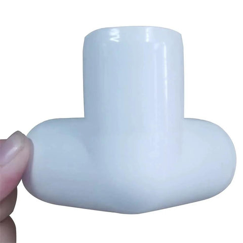 Close-up view of a One Half Inch PVC Tee Fitting 3 Way Elbow Connector Furniture Grade 90 Degree Side Outlet held by hand