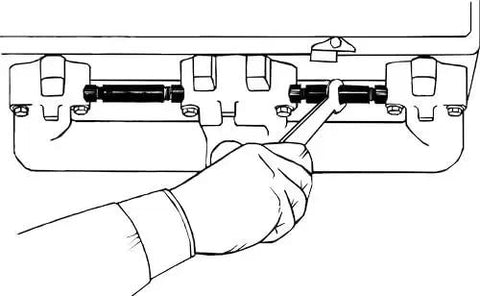 Exhaust Manifold Spreader for Small Block Chevy Engines Cast Iron Tool being used to align bolt holes on manifold