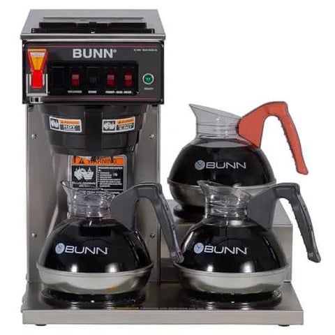 Automatic Commercial Coffee Brewer With 3 Lower Warmers 120V Delivers 3.9 Gallons Per Hour Hot Water Tap And Backup Pour Over SplashGard Deflector Stainless Steel Construction Compatible With Carafes Decanters And Airpots with three BUNN carafes on warmers.