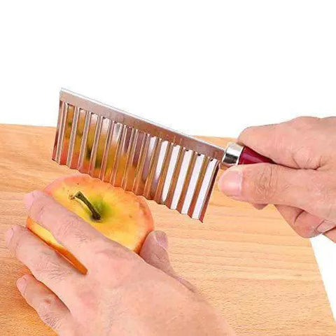 Crinkle Cut Potato Cutter Knife Stainless Steel Wave Slicer for potatoes, carrots, cucumbers in use slicing on a wooden board.