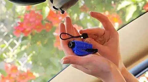 Hands installing Emergency Car Escape Tool Accessory Pack With Visor Clip Lanyard Keyring And Cable Tie For Resqme in car.