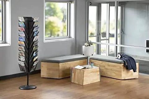 Onyx Rotating Mesh Magazine Holder With 30 Pockets Display Rack in a modern office lobby setting with natural light.