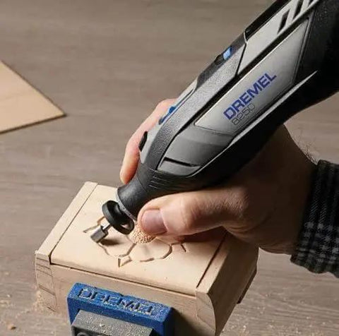 Close-up of Powerful 12V Cordless Rotary Tool With Brushless Motor From Dremel carving wood, emphasizing precision and use in DIY projects