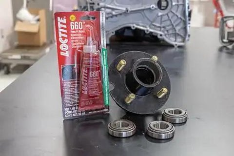 Shop Grade Automotive Press Fit Repair Adhesive For Worn Parts With High Strength Quick Cure Keeps Loosening And Leakage In Check 50 ml Bottle 1 Pack OEM Approved Bonding For Cylinders And Engine Components next to automotive parts on a table.