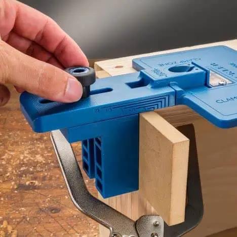 Corner Key Doweling Jig for Decorative Mitered Joints With Molded Reference Lines and Drill Guides, Pro Grade Dowel Tool Kit clamped on wood