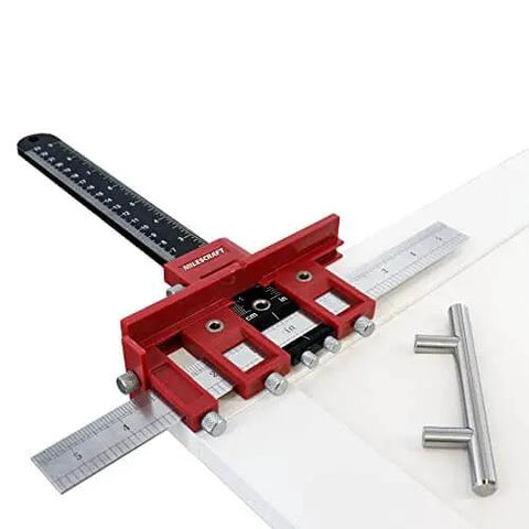 Red Ultimate Cabinet Jig Bundle For DIYers with Cabinet Hardware Jig and handle installation tools on white cabinet panel.