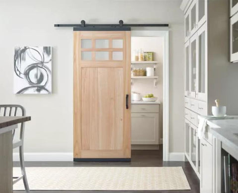 Soft Close Single Barn Door Hardware Kit in matte black for 36 inch doors, top mount track system installed in a kitchen.
