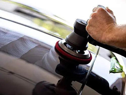 Person using a polisher on a car's clear coat to apply Ultimate Compound For Cars That Removes Oxidation Swirl Marks Water Spots And Scratches On Clear Coat Quickly And Safely With A Showroom Ready Shine Meguiar's.