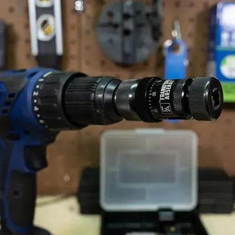 Pro Grade Universal Precision Case Trimmer For Reloading With HSS Construction And Drill Press Or Hand Drill Compatibility Depth Micrometer For Micro Adjustments Brass Shaving Ejection Port Universal Collet System And Storage Case By Frankford Arsenal attached to a drill press on a workbench