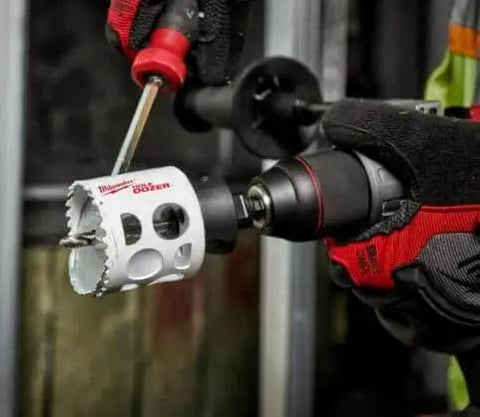 Hole Dozer Bi Metal Hole Saw For Metal Cutting Two And A Half Inch Diameter With One And Five Eighths Inch Max Cut Depth General Purpose Use High Speed Steel Teeth Get Clean Cuts Fast Arbor Not Included Milwaukee in use with drill.