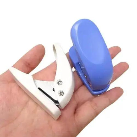 Two Pack Mini Hole Punch Set Handheld 6mm Single Hole Punches White And Blue Portable Punch Tool held in hand