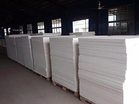 Ceramic fiber insulation boards, white, 24x12x1 in, stacked on pallets in a warehouse.