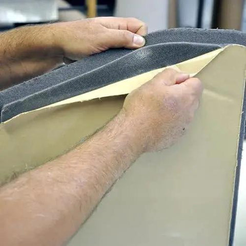 Close-up of Boom Mat Black Sound Deadening Headliner for Jeep Wrangler JL 2018 Up Custom Fit, being peeled for installation.
