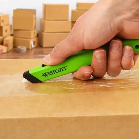 Hand using Ceramic Safety Box Cutter With Retractable Blade For Easy Large Box Opening on cardboard box