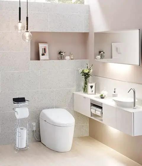 Bathroom with Free Standing Chrome Toilet Paper Holder With Reserve Shelf And Storage Basket next to modern sink