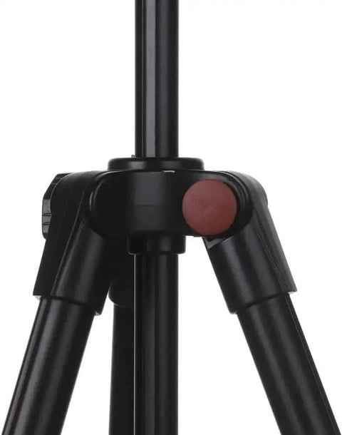 Close-up of a black camera tripod with adjustable legs and a red locking knob, focusing on the joint mechanism.