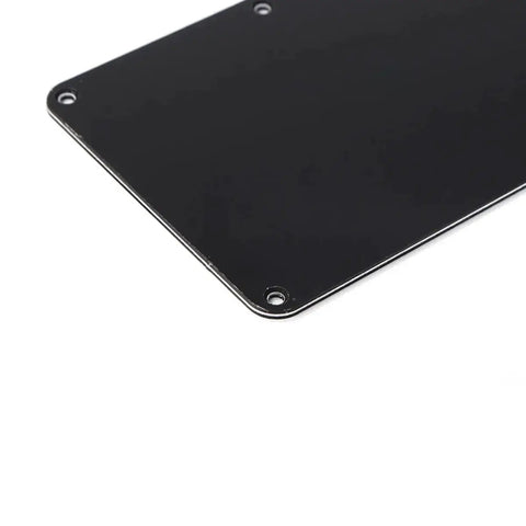 Close-up of black Electric Guitar Back Plate Cover with 6-hole plastic cavity backplate closed style for repair and refit.