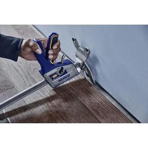 Quick Lift Construction Jack With 10 Inch Lift And 330 Lb Capacity being used to lift wooden flooring