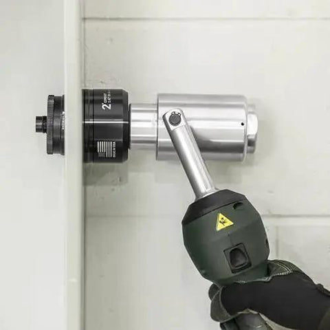 Using 11 Ton Battery Hydraulic Knockout Punch Kit With Slugbuster For Half Inch To Two Inch Conduits on wall