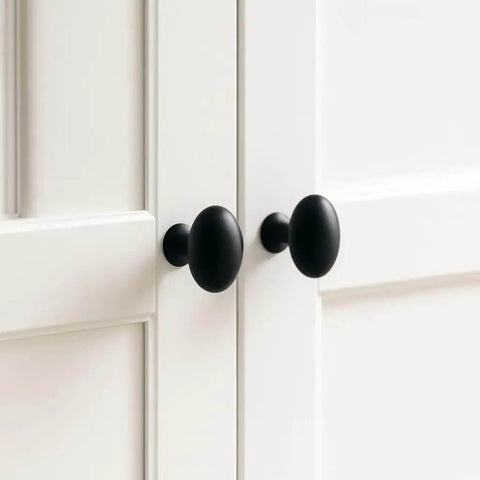 Oval Matte Black Cabinet Knobs 10 Pack For Kitchen And Furniture By EAXINTA installed on white cabinet doors
