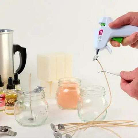 Person using hot glue gun with Hot Glue Sticks Mini 4 Inch Clear 30 Pack Multi Temp Wood Metal Glass Fabric on glass jars.