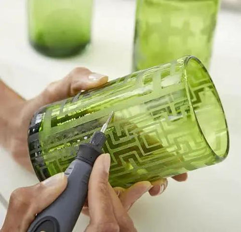 Close-up of Flex Shaft Rotary Tool Attachment With Comfort Grip And 36 Inch Cable For Precise Engraving Polishing Sanding Wood Carving And Jewelry Making Giving You Pro Grade Control By Dremel in use on a green glass.