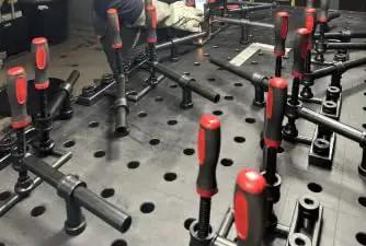 4-Pack 180 Degree Welding Fixture Screw Clamps for Five Eighth Inch Tables installed on workbench
