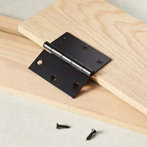 Interior Door Hinges Square 3.5 Inch Matte Black Pack Of 12 With 72 Mounting Screws Durable Steel Construction, shown on wood surface