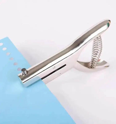 Tough As Nails Single Hole Punch for Crafts and Scrapbooks, quarter inch zinc alloy hole puncher used on blue paper.