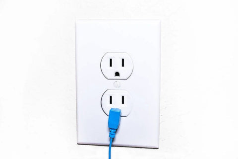 20 ft grounding cable with blue plug inserted into a white wall outlet