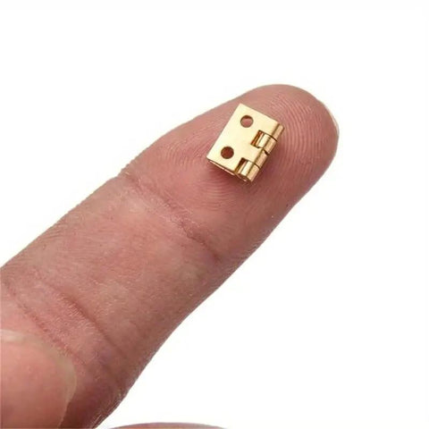Tiny Golden Mini Metal Hinge For 1 By 12 Dollhouse Cabinets And Boxes With Four Mounting Holes on fingertip, gold tone, 8x10 mm