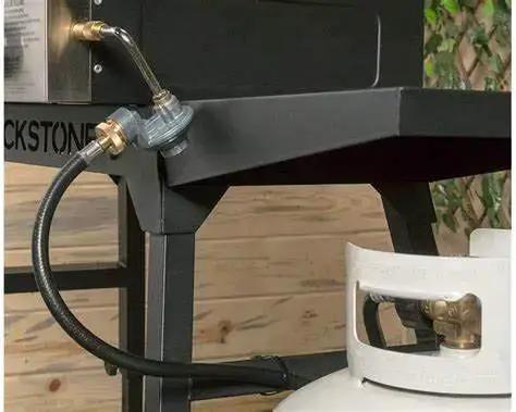 Propane Hose 1lb To 20lb Adapter For 12 Foot Connection attached to Blackstone griddle and LP tank, safe flow protection visible