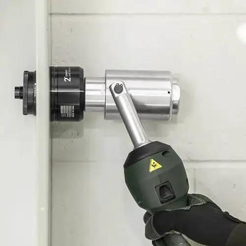 11-Ton Battery Hydraulic Knockout Punch Kit With Slug Buster for 1/2 to 4 Inch Conduit in action punching a metal surface