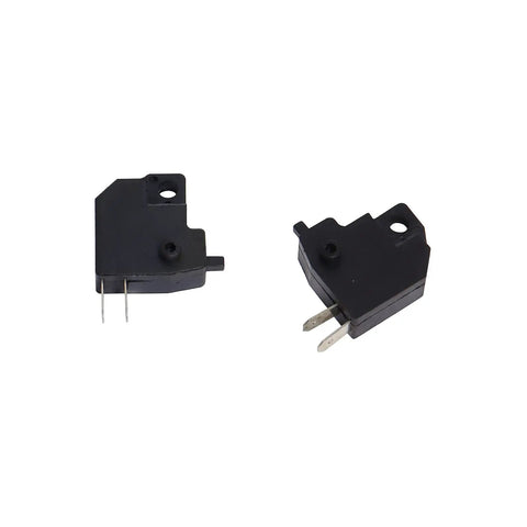 Close-up of black micro switches with metal prongs, used in various electronic applications.
