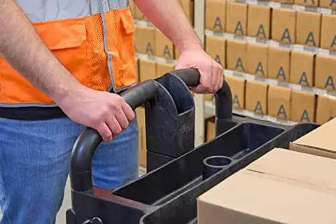 Person operating Two Shelf Foam Utility Cart With Lipped Shelves And Ergonomic Handle Black 500 Lb Capacity in warehouse environment