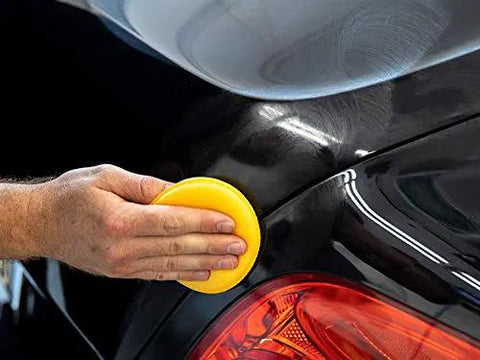 User applying Ultimate Compound For Cars That Removes Oxidation Swirl Marks Water Spots And Scratches On Clear Coat Quickly And Safely With A Showroom Ready Shine Meguiar's with a yellow polishing pad.
