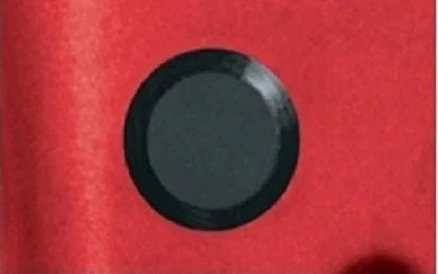 Black plastic hole plug from Fifty Piece Flush Mount Plastic Hole Plug Set For Auto Body And Sheet Metal, shown installed in red panel.
