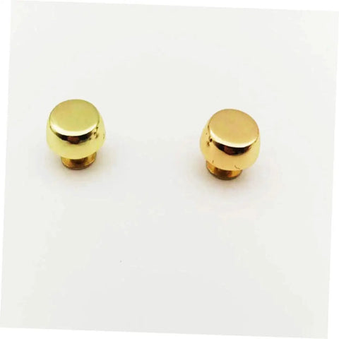 Close-up of brass rivets from Leathercraft Bag Rivets Set For Purses Belts And Handbags DIY Decoration on white background.