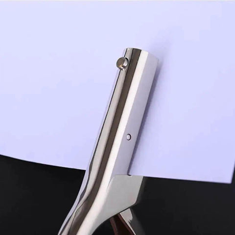 One Hole Metal Punch Tool For Crafts On The Go Circle Slot Handheld Punch creating a hole in paper, showing chrome finish.