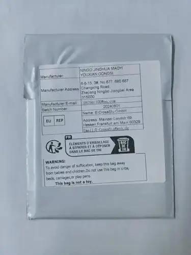 Shipping label on grey package with manufacturer details and safety warning
