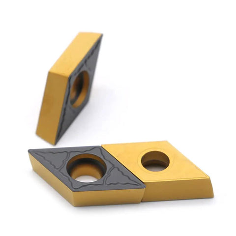 CNC Carbide Inserts Pro Grade DCMT 32.51 And DCMT 11T304 PM, showing gold and black inserts with circular holes and chip breaker edges.